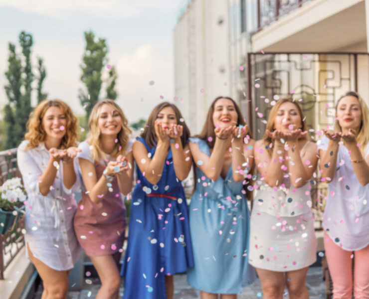 Bridesmaids celebrating their frriend's wedding with confetti