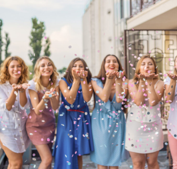Bridesmaids celebrating their frriend's wedding with confetti