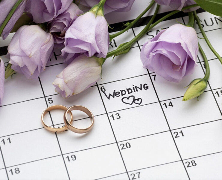 Roses and rings on a calendar with the wedding date written on it (Photo: courtesy of Magnific)