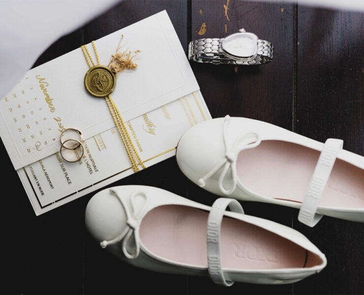 A pre-wedding image: bridal shoes, menus and a heart-shaped watch