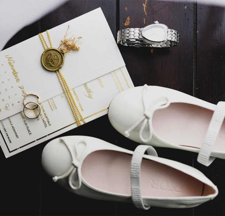 A pre-wedding image: bridal shoes, menus and a heart-shaped watch