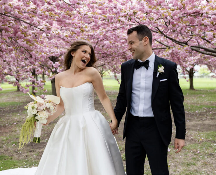 Spontaneous newlywed laughter, hand-in-hand